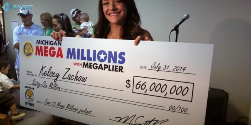 Người chiến thắng cầm tấm séc giải thưởng lớn từ xổ số kiểu Mỹ.